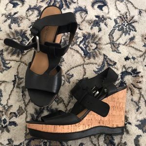 Black leather strapped wedges.